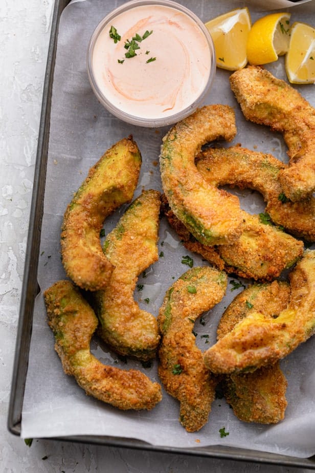 Avocado fries on a tray with spicy mayo sauce