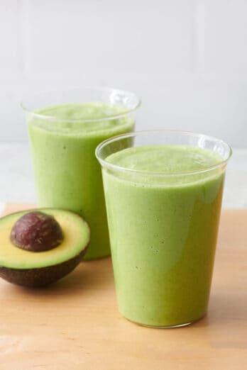 Avocado smoothie divided into to glasses.