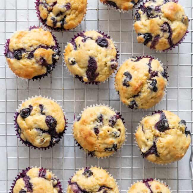 Banana blueberry muffins after baking and cooling on a wire rack.