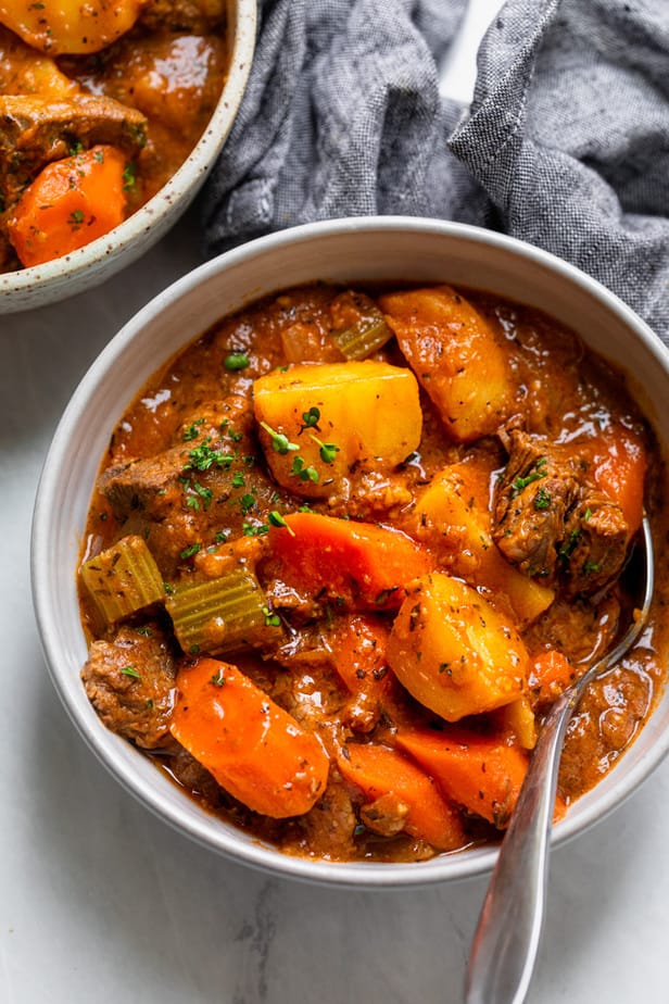 Beef stew in a bowl with a spoon