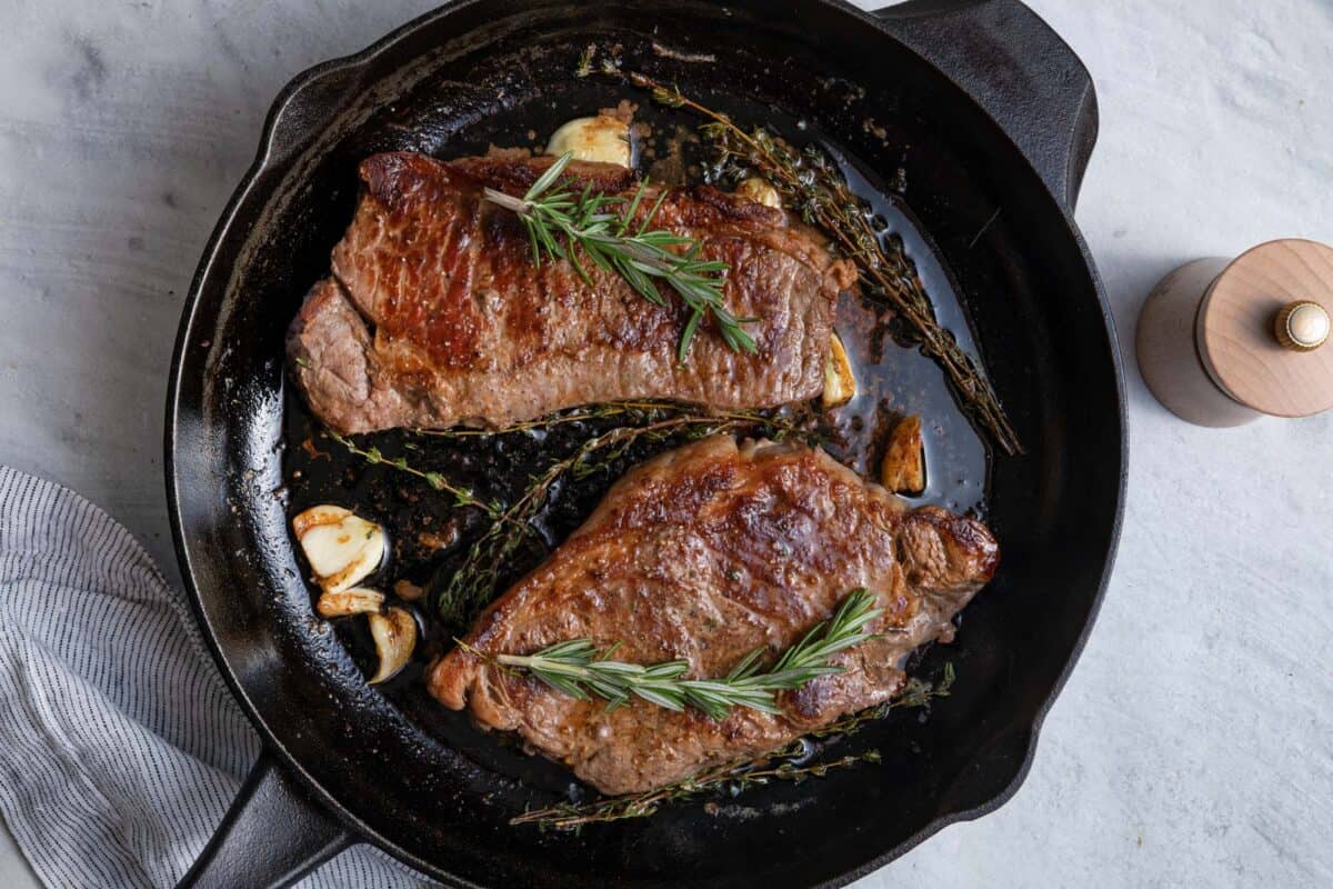 Cast iron skillet with ribeye steak cooked inside