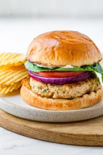 Ground chicken burger served with potato chips