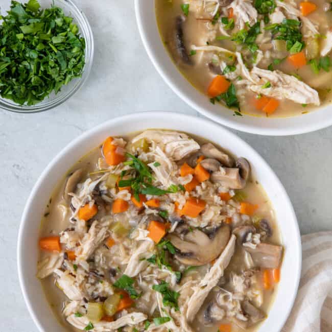 2 bowls of soup garnished with fresh parsley.