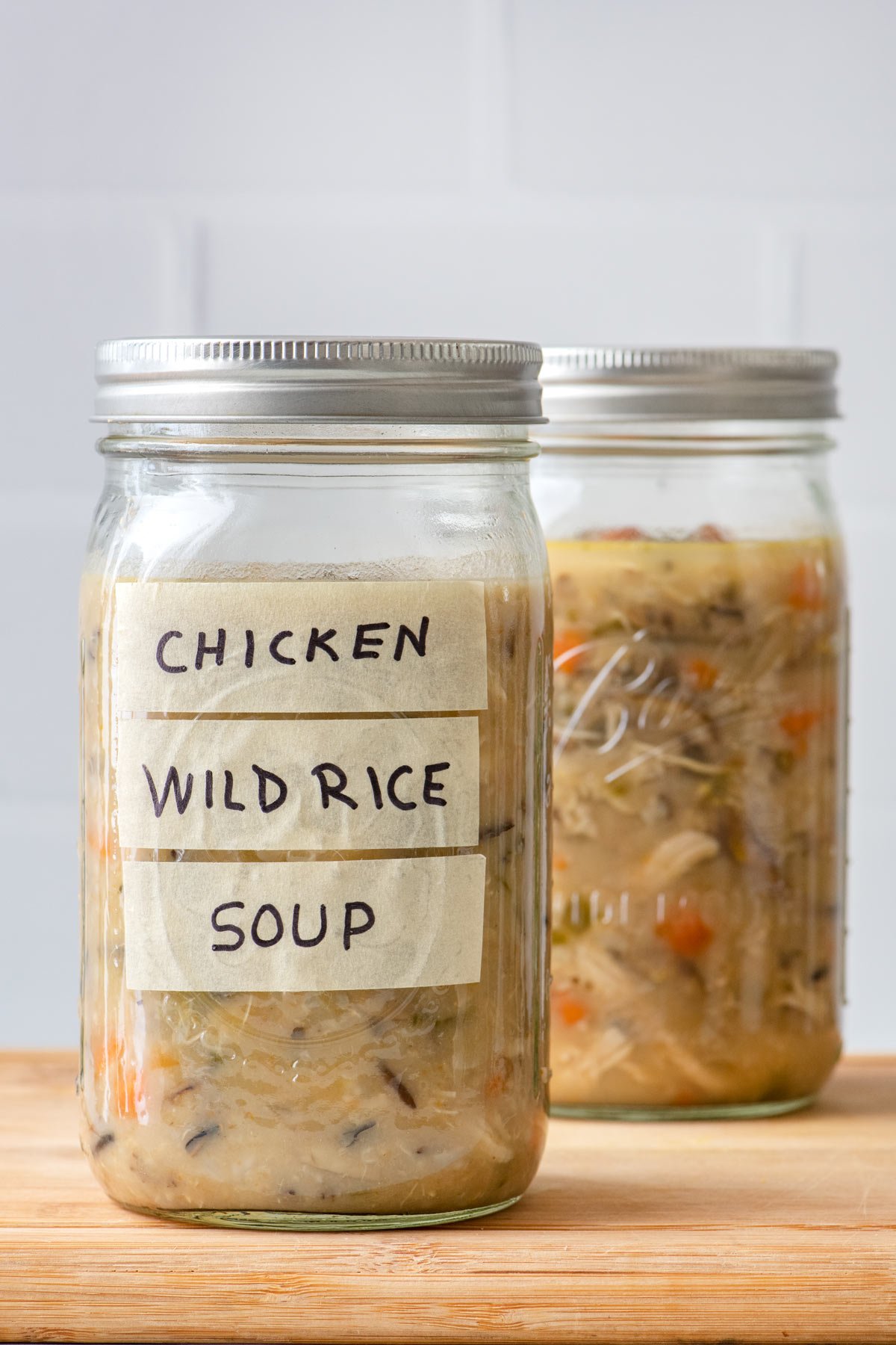 Mason jar with soup sealed inside for storing in the freezer.