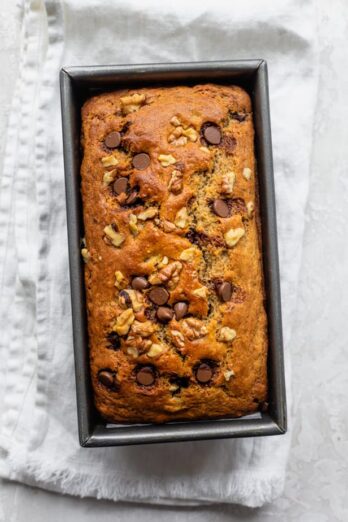 Banana bread in the loaf pan cooling after coming out of the oven