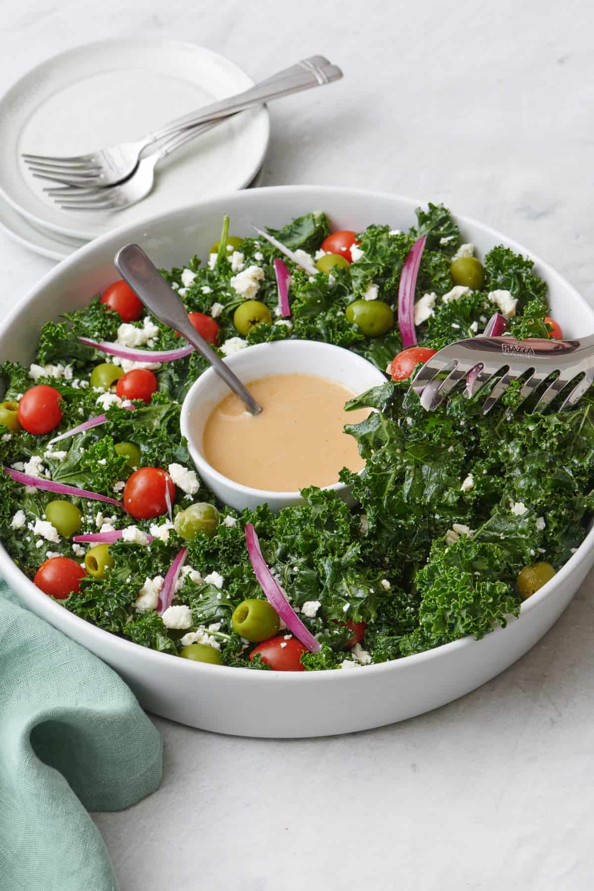 Tongs lifting up a serving of the Christmas wreath salad.