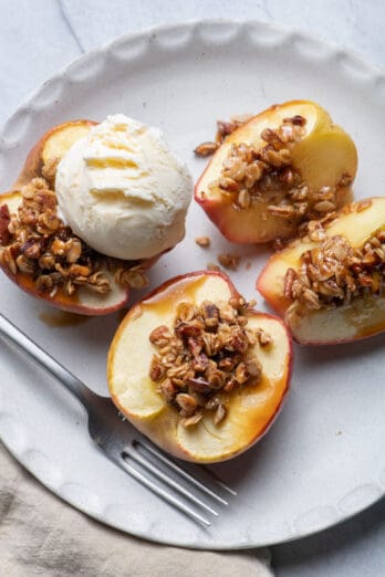 Cinnamon Baked Apples with Oats & Pecans mixture on top and scoop of vanilla ice cream