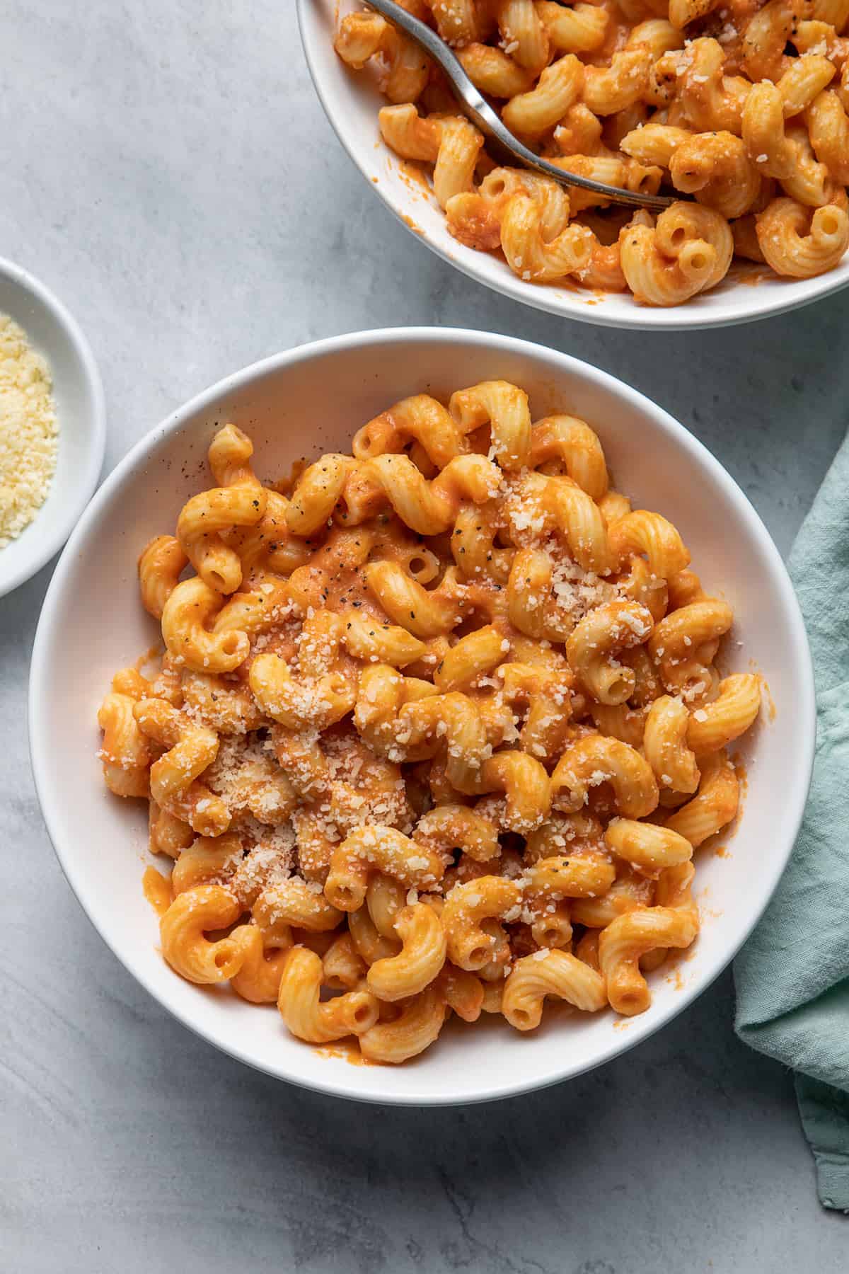 2 bowls of the pumpkin pasta served with side of grated parmesan cheese