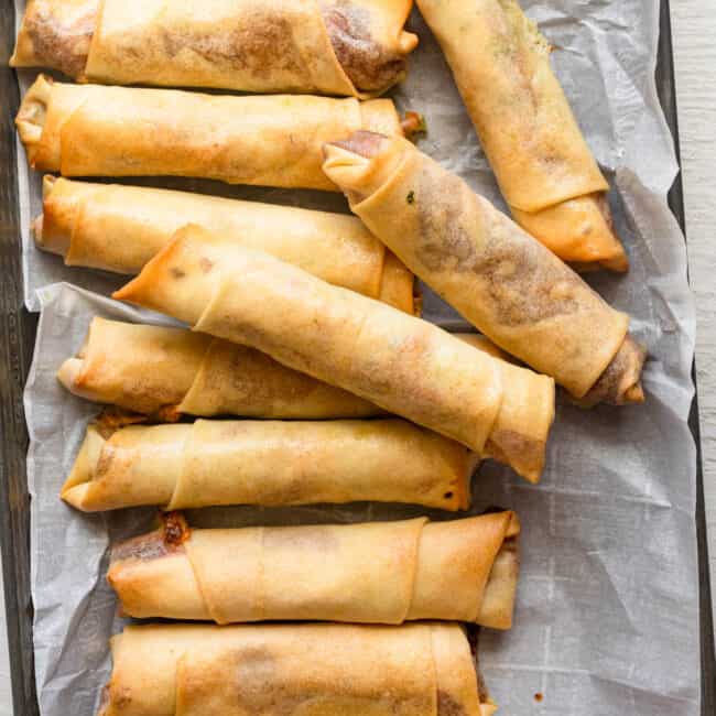 Tray of crispy cheese rolls baked in the oven