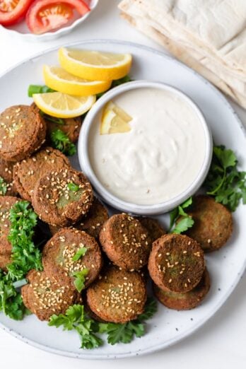 Large platter of Lebanese falafel served with tahini sauce and lemons