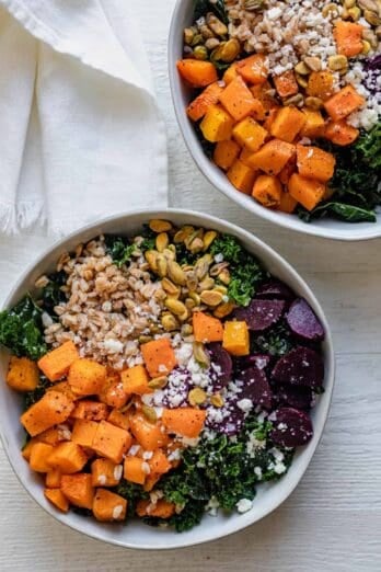 2 fall grain bowls made with butternut squash, kale, farro, beets, feta and pistachios