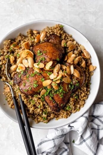 Freekeh with chicken served with toasted nuts and herbs