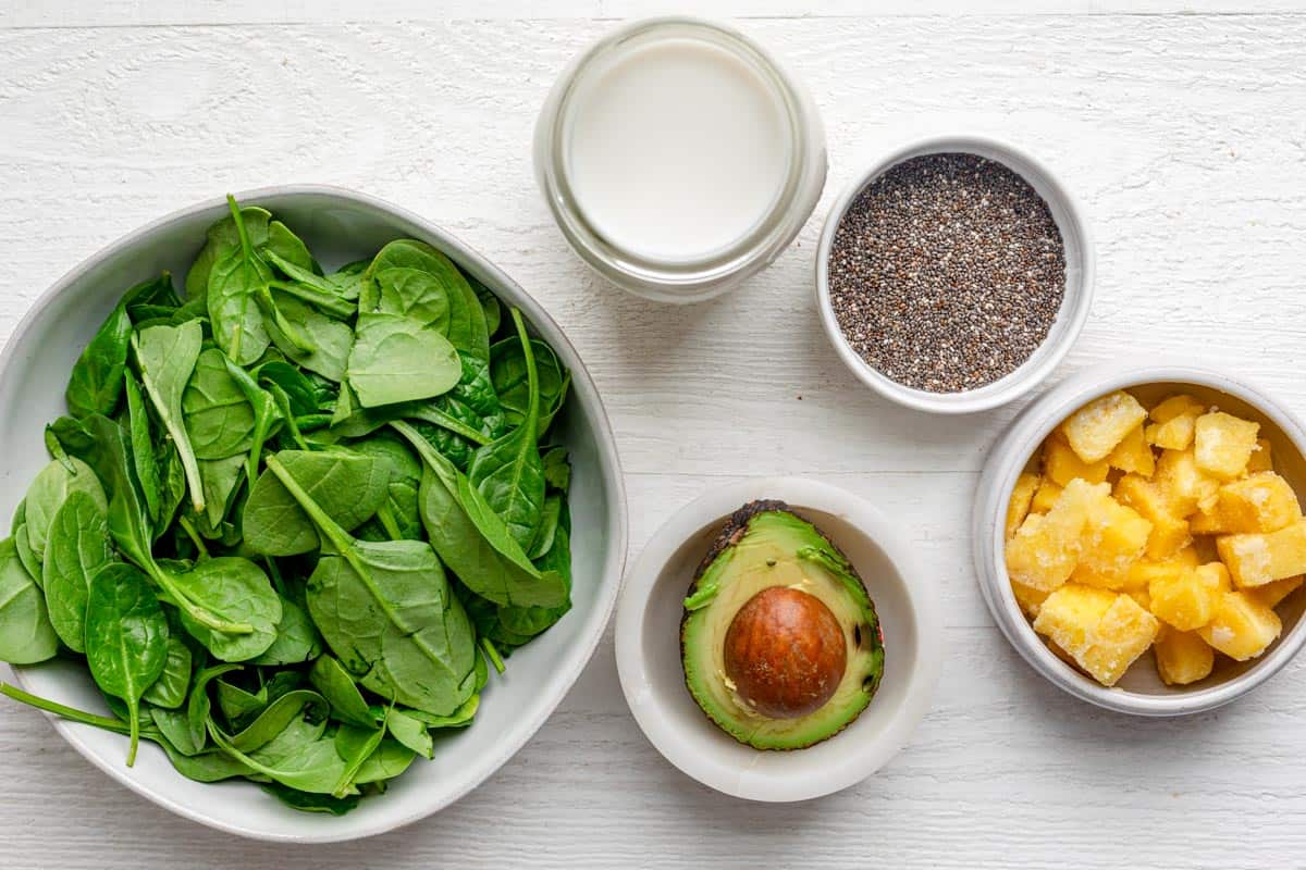 Ingredients to make the drink - spinach, almond milk, pineapple, avocado & chia seeds