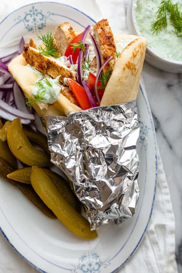 Chicken gyro after grilling served with pickles and tzatziki