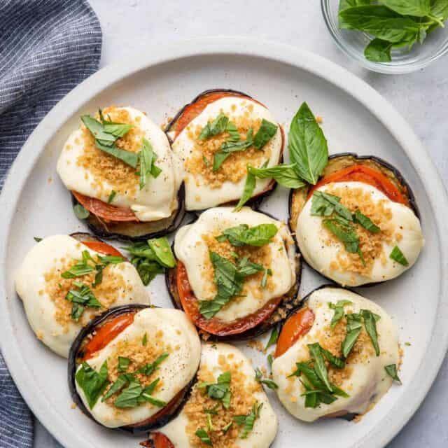 Grilled eggplant parmesan topped with grilled tomatoes, mozzarella cheese and parmesan breadcrumbs