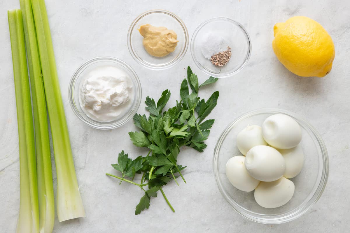 Cutting board with chef's knife and chopped eggs on chopping board