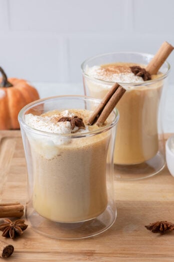 Two glasses of homemade pumpkin spice latte viewed at an angle.