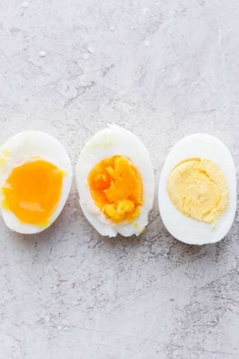 3 boiled eggs, soft, medium and hard - sliced in half to show consistency