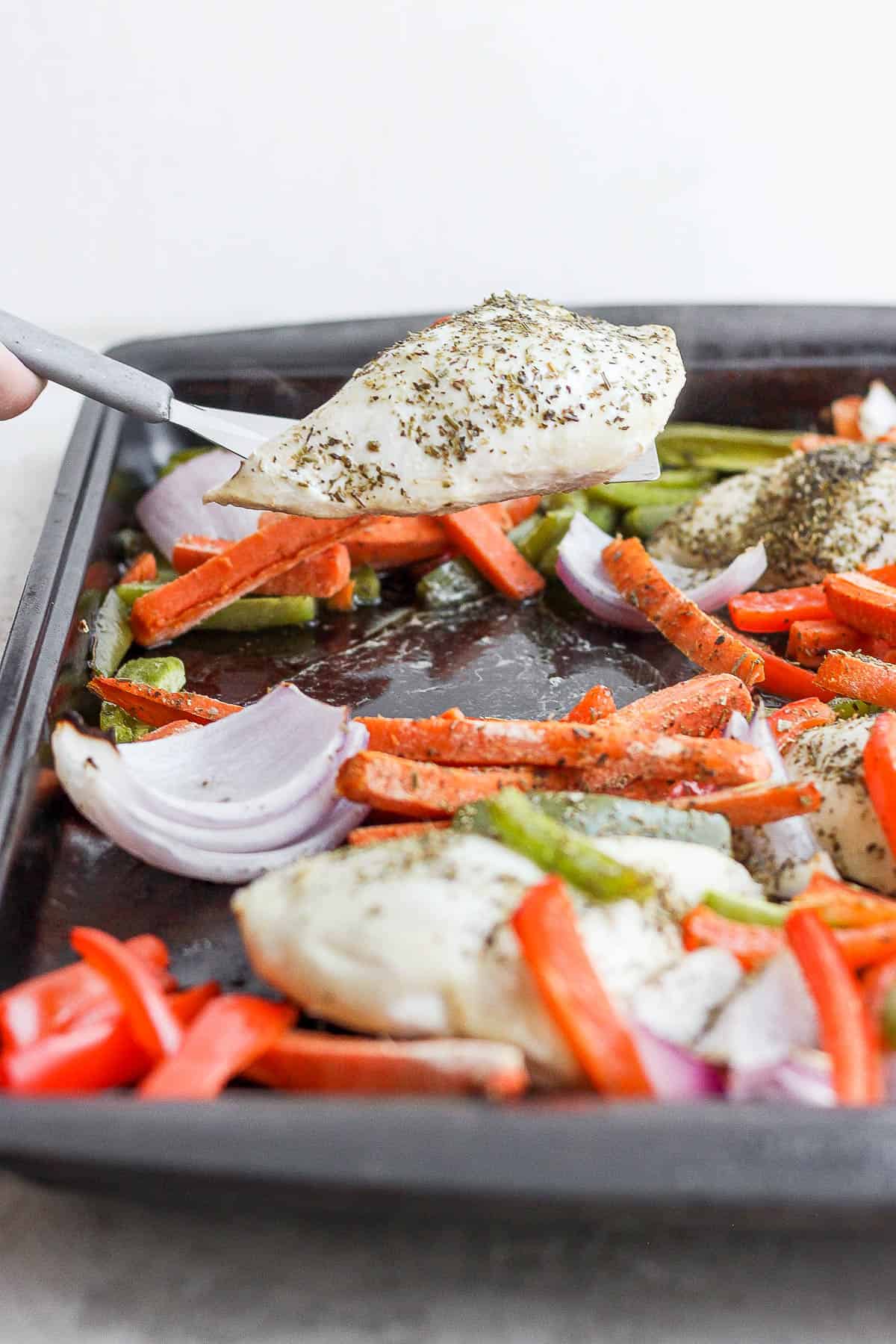 Serving chicken from sheet pan meal