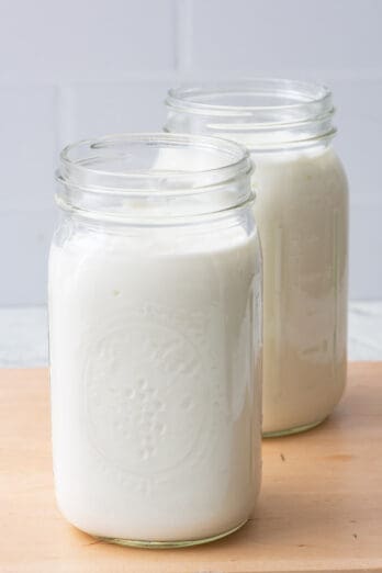 2 mason jars full of homemade yogurt.