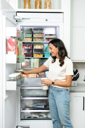 Yumna stocking a freezer.