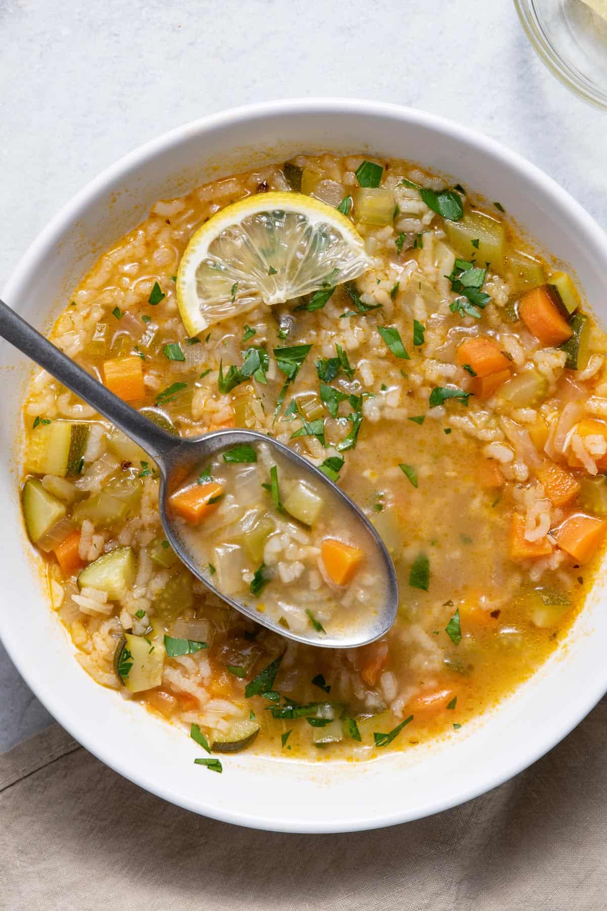 Top down shot of Lemon Rice Soup being scooped with a spoon