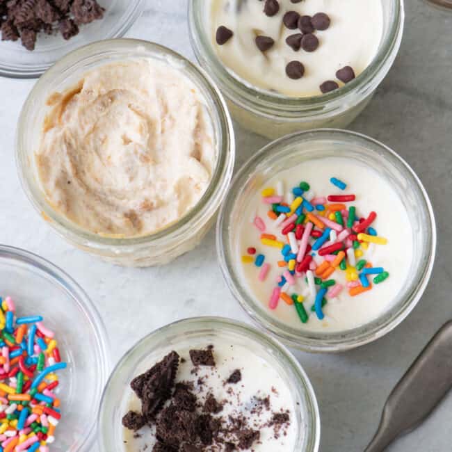 Top view of ice made in 4 mason jars with different toppings in each jar.