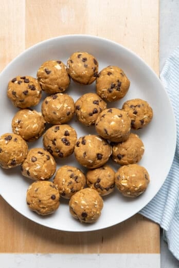 Bowl of no bake pumpkin balls with chocolate chips