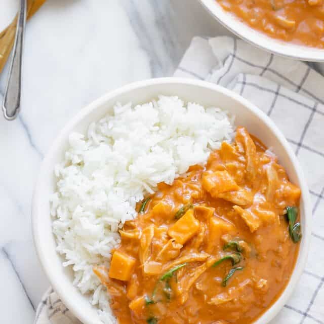 Bowl of white rice with peanut soup over the rice