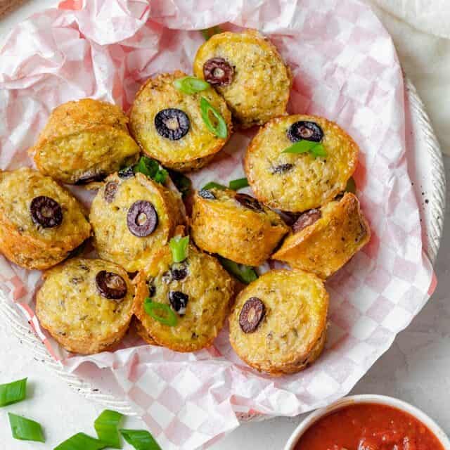 Large plate of pizza bites served with marinara sauce