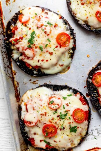 Close up shot of the portobello mushroom pizzas with the toppings after cooking with cheese melting