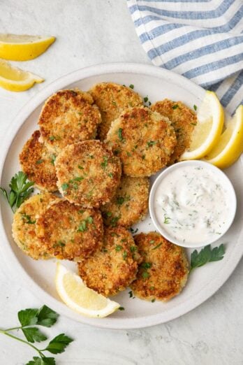 Tuna potato cakes served with tzatziki and lemon wedges.