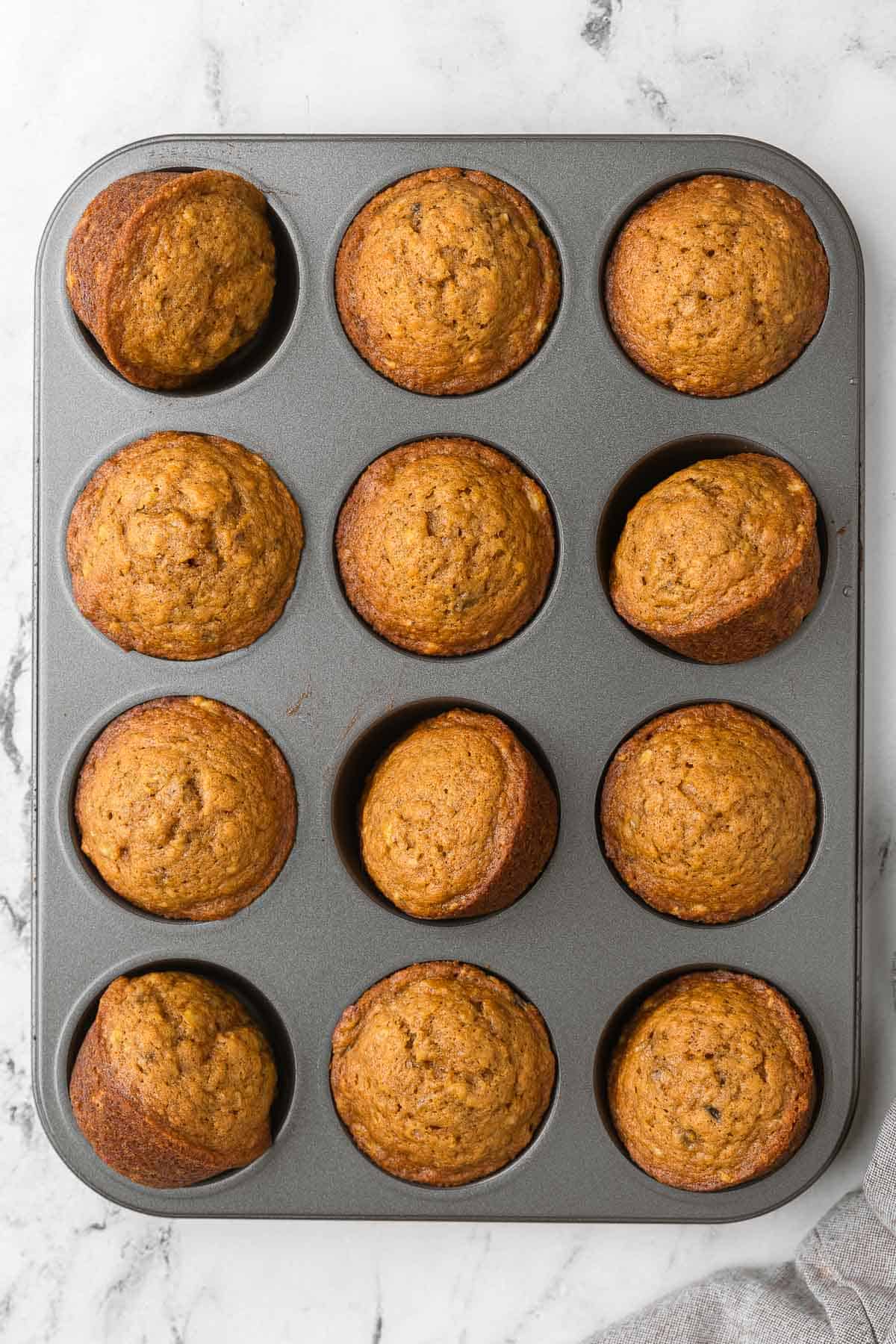 Pumpkin Banana muffins in a muffin pan.