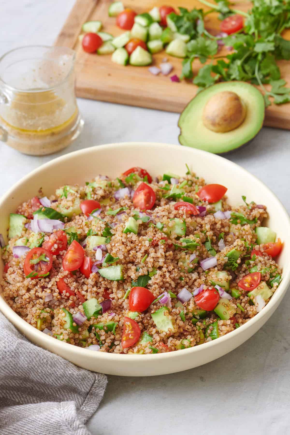 Final plated large bowl of quinoa avocado salad