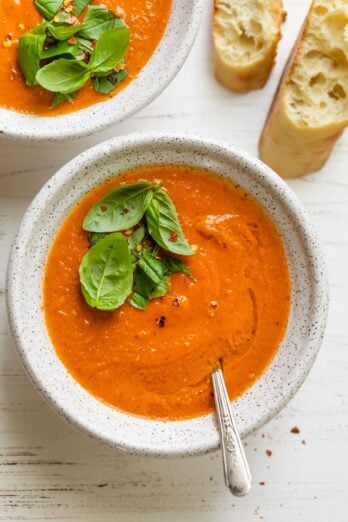 Final plated roasted tomato soup topped with fresh basil