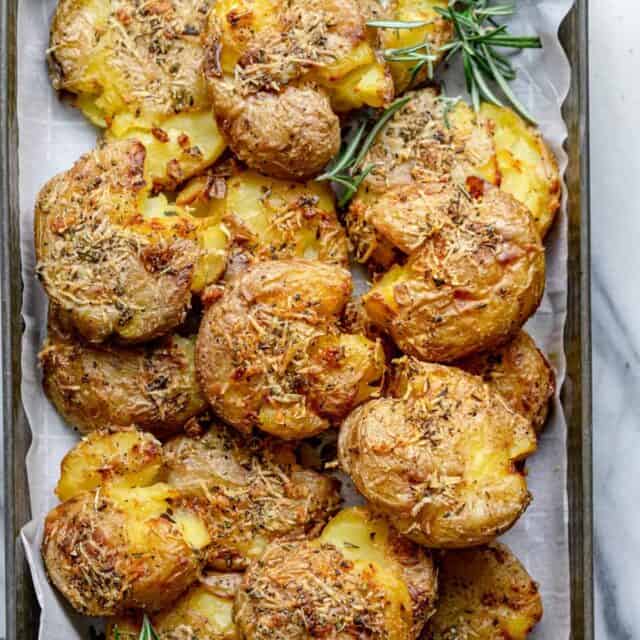 These Rosemary Garlic Smashed Potatoes are a best of both worlds potato recipe - mashed and roasted! They are soft on the inside, crispy on the outside and bursting with rosemary garlicky flavor. It's a creative healthy side-dish the whole family will love!