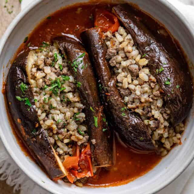 Final cooked stuffed eggplant cut in half to show the rice and beef stuffing