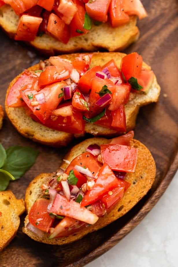 Tomato and basil brushetta on a wooden board