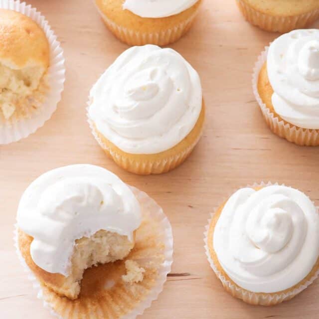 Vanilla cupcakes with bite taken out of one to show consistency