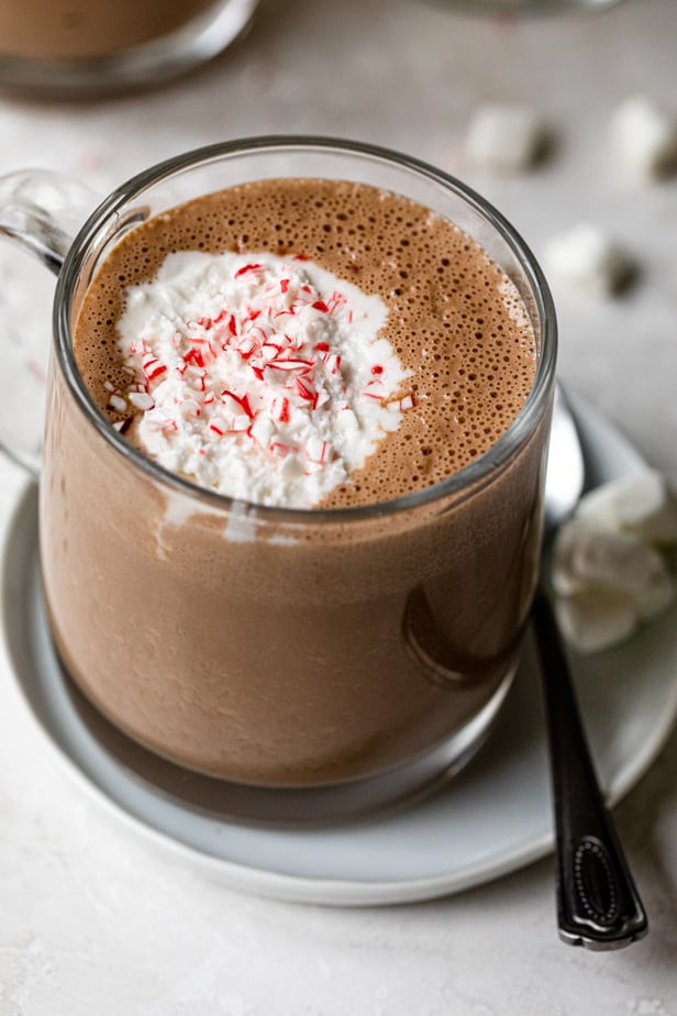 Close up shot of a clear mug of hot chocolate made with homemade cashew milk