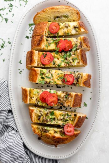 Final Vegetarian Egg Boat, sliced and garnished with sliced tomatoes