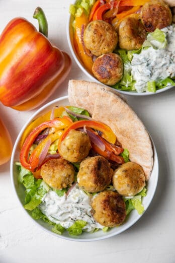 Two vegetarian gyro bowls with Aloha peppers on the side